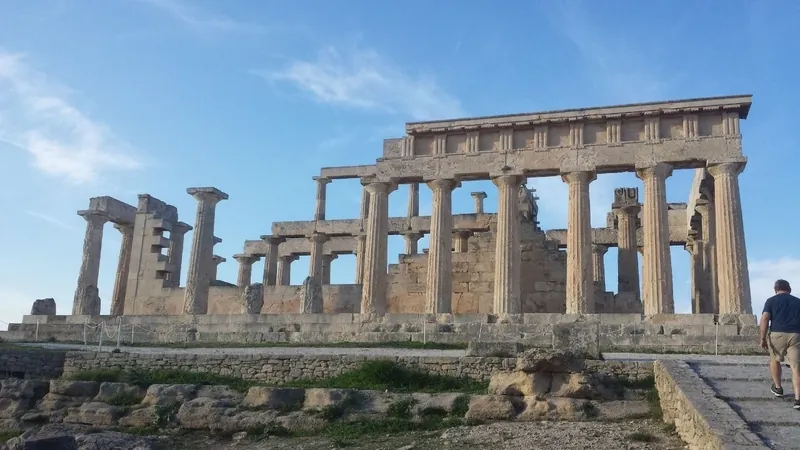 The columns and entablature of the Temple of Aphaia on Aegina against a blue sky