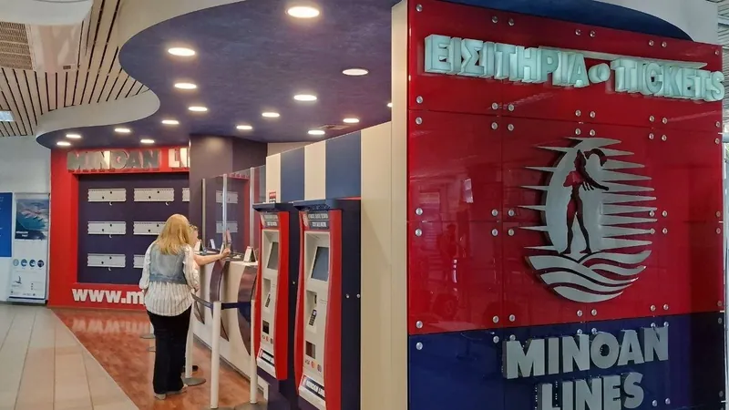 Ticket machines and a red ticket office sign inside a ferry port terminal
