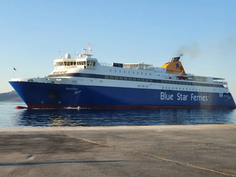 A Blue Star Ferries ship arriving at a quay on Naxos on a bright morning